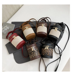 Flat lay of six contrast color cylinder bucket bags with leopard print and canvas textures