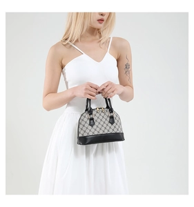 Detailed shot of a mini shell bag featuring vintage canvas and black leather accents
