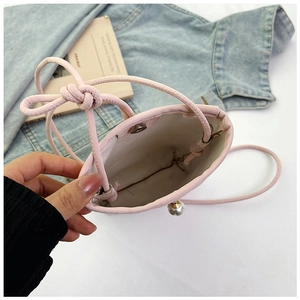 Pink faux leather bucket bag with a pearl pendant and magnetic snap closure