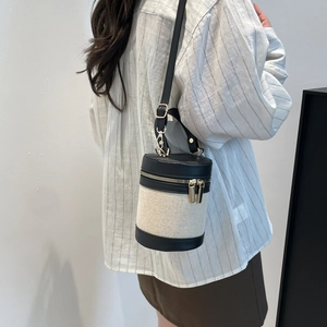 Contrast cylinder bucket bag with woven canvas and black leather accents for women