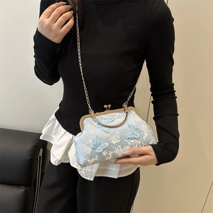 Light blue shell bag with floral lace embroidery and 3D butterfly accent on chain strap