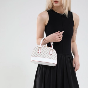 Classic white and brown patterned dome bag with red trim and top handles