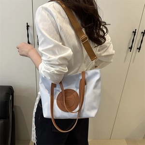 Women's casual tote bag in blue and white gradient with brown leather handles and strap