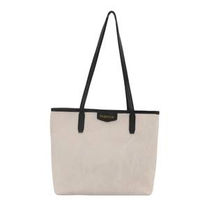 Minimalist cream nylon tote bag with black leather handles and fashion logo patch
