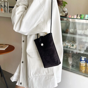 Vertical black crossbody phone bag with vintage floral pattern and pearl knot detail