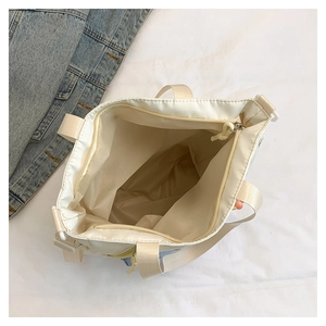 Top view of spacious cream canvas tote bag interior with zipper and wide strap