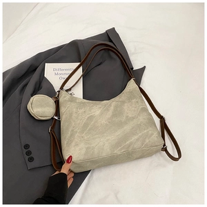 Close-up of beige marble-patterned tote bag with brown leather strap and mini coin purse