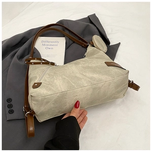 Detail of beige tote bag with dark brown straps and a matching round mini coin purse
