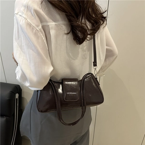 Dark brown patent leather baguette shoulder bag with adjustable strap in minimalist style