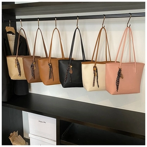 Selection of colorful faux leather tote bags featuring FASHION embossing and leaf charms