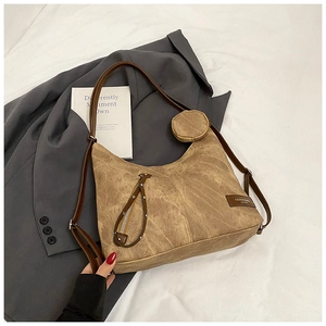 Detail of khaki canvas tote with brown leather straps and small detachable round pouch