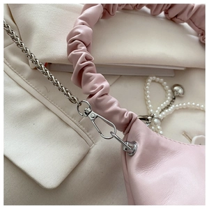 Detail of pink soft leather cloud bag showing silver metal hooks and chain strap