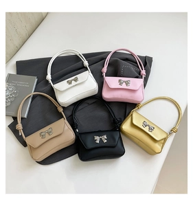 Detailed view of women's bow shoulder bags in five colors with smooth faux leather texture