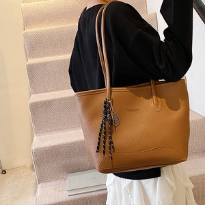 Caramel lychee grain tote bag with FASHION logo and tennis racket pendant detail