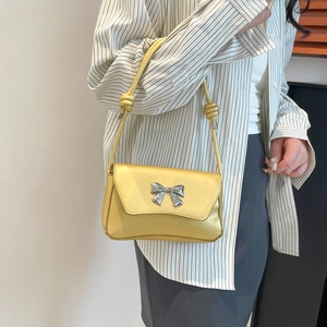 Minimalist metallic gold bow shoulder bag for women with elegant knotted strap design