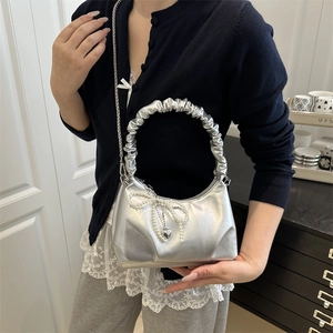 Silver pleated half-moon bag with pearl bow and heart charm for modern women