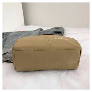 Detailed side view of khaki nylon bag showing large capacity and white DUONING logo print