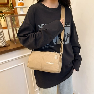 Minimalist beige crossbody bag with DUONING logo for casual daily streetwear style