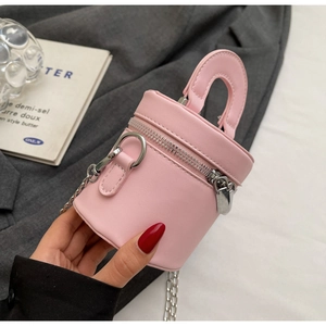 Close-up of pink mini bucket bag featuring dual zippers and silver chain hardware
