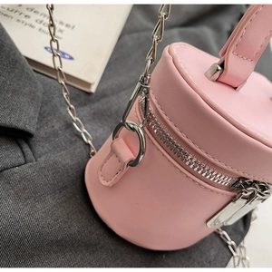 Detail of pink bucket bag with smooth PU texture and silver zipper hardware