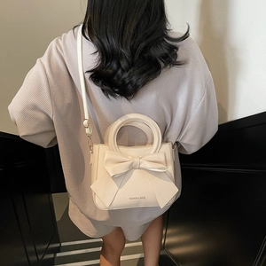 Elegant cream white trapezoid handbag with large bow and fashion lettering on matte PU leather