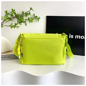 Neon green oxford crossbody bag with adjustable strap and fashion label detail