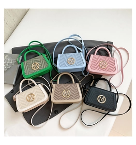 Detailed view of woven texture handbags with metal M buckle in six vibrant colors