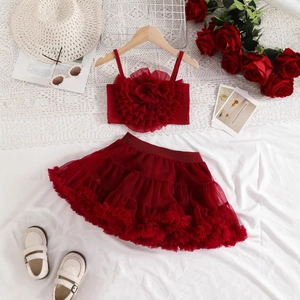 Detailed flat lay of red girls' two-piece set with 3D rose camisole and layered tutu skirt