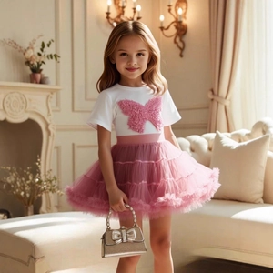 Detail of girls' white T-shirt with 3D pink butterfly and layered tulle tutu skirt