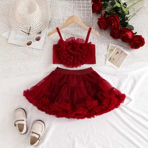 Detailed view of red tutu skirt set featuring 3D floral camisole and layered mesh fabric