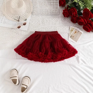 Detail of red tiered tutu skirt with elastic waist and ruffled mesh layers for girls