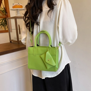 Vibrant lime green leather handbag and crossbody bag with matching triangle charm