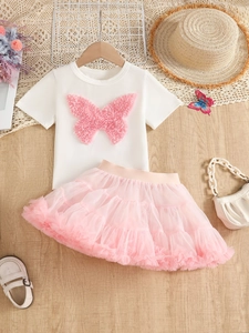 Detail of white cotton T-shirt with pink 3D butterfly and layered mesh tutu skirt set