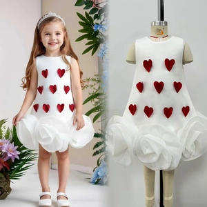 Detail of girls' white sleeveless party dress with red 3D hearts and rose skirt texture