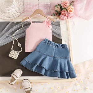 Detail of pink ribbed tank top with bow and blue denim tiered skirt for girls