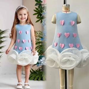 Detail of light blue sleeveless dress featuring 3D pink hearts and white mesh petals