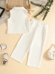 Flat lay of girl's white two-piece suit with sleeveless vest and wide-leg trousers