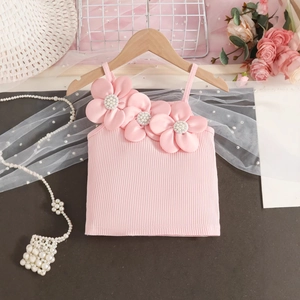 Close-up of pink ribbed cotton tank top with 3D satin flowers and pearl accents