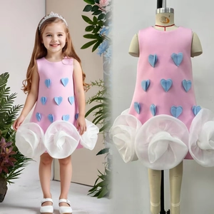 Pink girl dress with blue heart appliques and 3D floral hem details shown on model