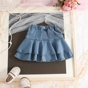 Detailed close-up of light blue denim tiered ruffle skirt with elastic waist for girls