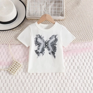 Close-up of white cotton T-shirt with butterfly print and pearl details for girls