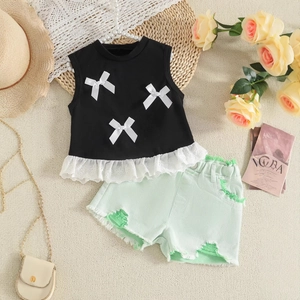 Detail of girl's summer outfit with bow lace tank top and distressed denim shorts