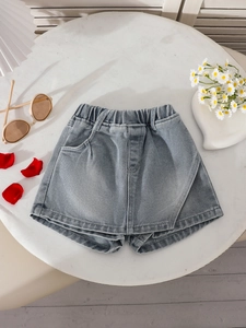 Girls denim skort in washed blue featuring an elastic waist and stylish front wrap design