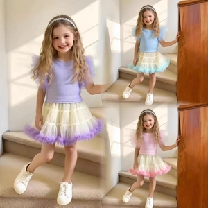 Detail of girls' tutu skirt set featuring flutter mesh sleeves and tiered mesh tulle layers