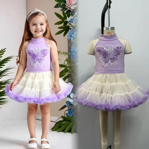 Detail of beaded butterfly applique and layered tutu skirt on a girls princess dress