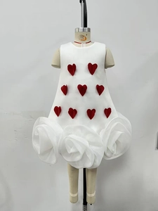 Detail of white sleeveless A-line girl dress with red 3D hearts and large rose petal hem
