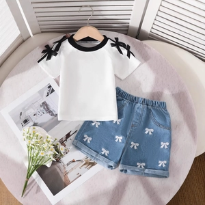 Detailansicht Mädchen T-Shirt mit schwarzen Schleifen und bestickten Denim Shorts