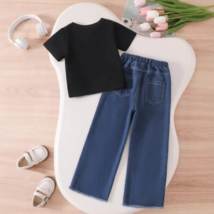 Flat lay of girl's black t-shirt and blue denim wide-leg pants with frayed hem details