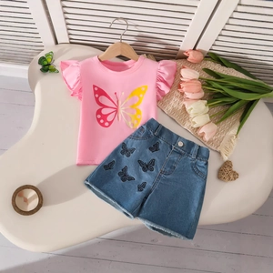 Close-up of pink butterfly print t-shirt and denim shorts with floral embroidery