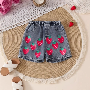 Close-up of girls denim shorts featuring cute strawberry prints and elastic waistband